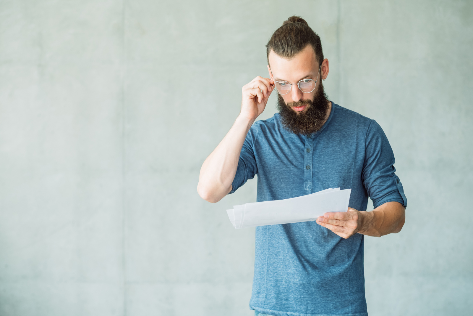 man reading script papers focused screen writer